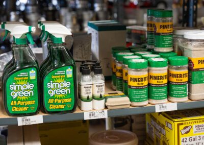 Industrial cleaning supplies, including Simple Green and Pinerite soap, on a workbench at PT Hose & Bearing.