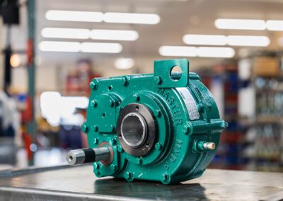 Industrial gearbox used for power transmission in machinery, shown on a metal workbench at PT Hose & Bearing.