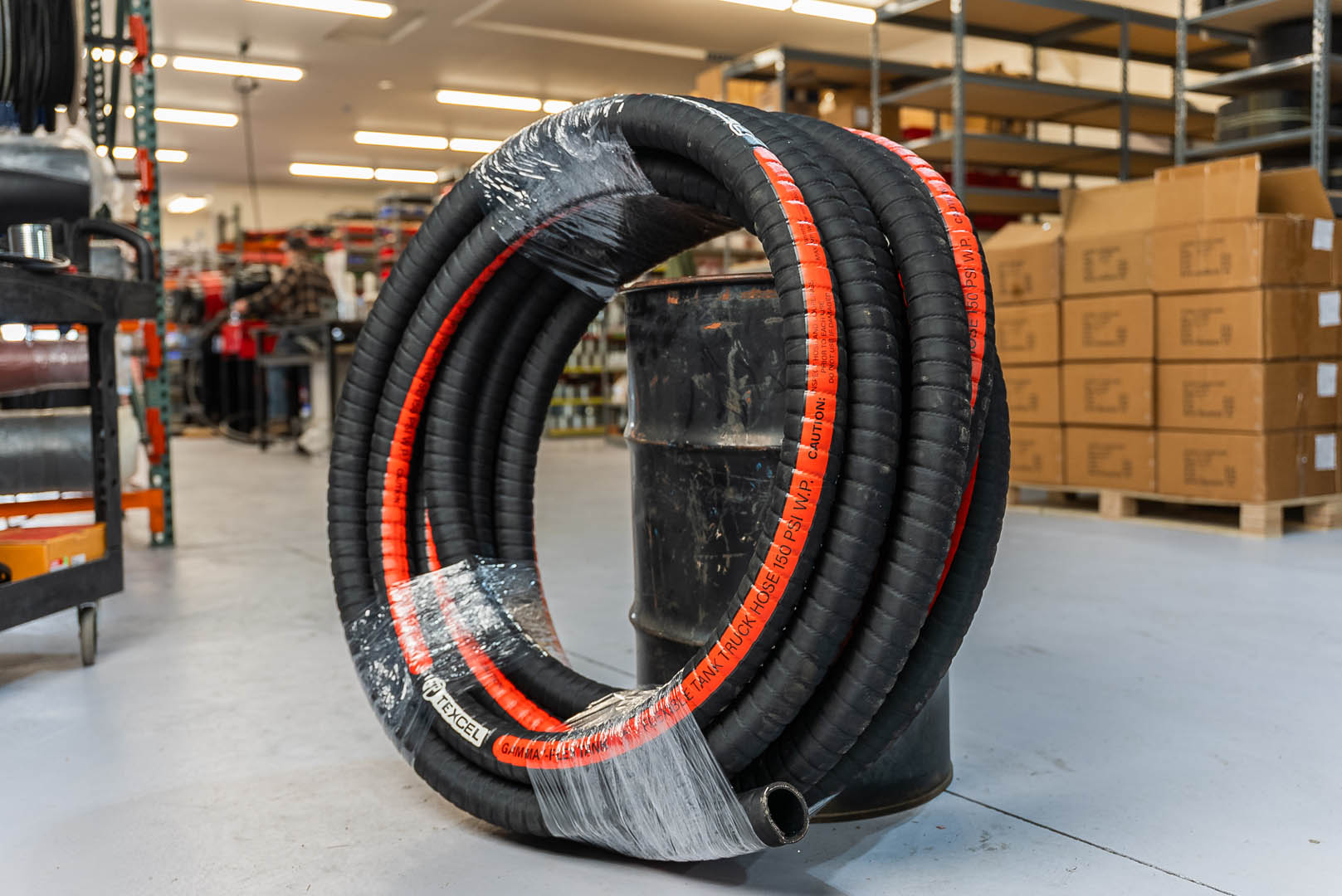 Oilfield Hose Oilfield hose for transporting fluids in industrial applications, shown in the warehouse at PT Hose & Bearing.