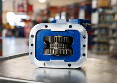 Durable Power Take-Off (PTO) for efficient power transfer in agricultural and industrial equipment, shown on a metal workbench at PT Hose & Bearing.